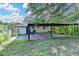 Exterior view of home's backyard with covered patio and lawn at 3991 Adamsville Sw Dr, Atlanta, GA 30331