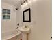 Bright bathroom featuring a tub, shower, vanity, and black hardware accents at 3991 Adamsville Sw Dr, Atlanta, GA 30331