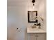 Well-lit bathroom features a sink with a vanity and a decorative mirror and lighting at 3991 Adamsville Sw Dr, Atlanta, GA 30331