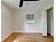 Bedroom featuring wood flooring, white walls, and a window with a view at 3991 Adamsville Sw Dr, Atlanta, GA 30331