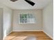 Bedroom featuring wood flooring, white walls, and a window with a view at 3991 Adamsville Sw Dr, Atlanta, GA 30331