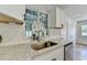 Modern kitchen sink with white cabinets, subway tile backsplash, and granite countertops at 3991 Adamsville Sw Dr, Atlanta, GA 30331
