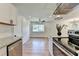 Spacious kitchen with granite counters, stainless appliances, open to living area and a ceiling fan at 3991 Adamsville Sw Dr, Atlanta, GA 30331