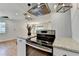 Close up of oven and island with view into bright and open concept living area at 3991 Adamsville Sw Dr, Atlanta, GA 30331