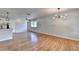 Open-concept living space with natural hardwood floors and modern lighting fixtures at 3991 Adamsville Sw Dr, Atlanta, GA 30331