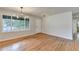 Bright living room featuring hardwood floors, large windows, and a modern light fixture at 3991 Adamsville Sw Dr, Atlanta, GA 30331