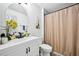 Clean bathroom with a vanity, round mirror, and chevron shower curtain at 5077 Martindale Ln, Stone Mountain, GA 30088
