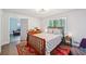 Bright bedroom with wood floors, classic rug, and view to sitting room at 5077 Martindale Ln, Stone Mountain, GA 30088