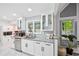 Bright kitchen features white cabinetry, stainless steel appliances, granite countertops, and natural light at 5077 Martindale Ln, Stone Mountain, GA 30088
