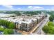 Aerial view of apartment complex surrounded by lush trees and an expansive parking lot at 5300 Peachtree Rd # 1608, Chamblee, GA 30341
