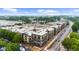 Aerial view of apartment complex surrounded by lush trees and an expansive parking lot at 5300 Peachtree Rd # 1608, Chamblee, GA 30341