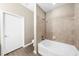 Bathroom showcasing a tiled shower and tub combination, next to a closed door at 5300 Peachtree Rd # 1608, Chamblee, GA 30341