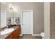 Bathroom featuring granite counters, tiled floors and walls, and modern lighting fixtures at 5300 Peachtree Rd # 1608, Chamblee, GA 30341