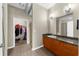 Well-lit bathroom featuring granite counters and tile flooring, leading to the walk-in closet at 5300 Peachtree Rd # 1608, Chamblee, GA 30341