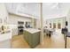 Modern kitchen with white and green cabinets, stainless steel appliances, light countertops, and light hardwood floors at 5300 Peachtree Rd # 1608, Chamblee, GA 30341