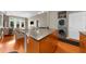 Bright kitchen features an island with granite counters, stainless appliances and a view of the dining and living areas at 5300 Peachtree Rd # 1608, Chamblee, GA 30341