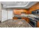 Well-lit kitchen with wood cabinets, stainless steel appliances, and an island with granite countertop at 5300 Peachtree Rd # 1608, Chamblee, GA 30341