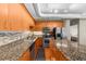 Spacious kitchen with wood cabinets, stainless steel appliances, granite countertops, and tiled backsplash at 5300 Peachtree Rd # 1608, Chamblee, GA 30341
