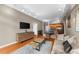 Hardwood flooring, large TV, and open kitchen create a welcoming ambiance in this combined living and dining space at 5300 Peachtree Rd # 1608, Chamblee, GA 30341