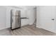 Basement area with stainless steel refrigerator, sink, and access to stairs at 1122 Cayuga Ct, Dacula, GA 30019