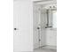 A view of the bathroom with a white door to the left and a sink visible through the doorway at 1122 Cayuga Ct, Dacula, GA 30019