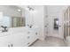 Bathroom features double sinks, vanity with white cabinets and a large mirror at 1122 Cayuga Ct, Dacula, GA 30019