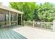 This deck features a screen porch and wooden deck overlooking large trees at 1122 Cayuga Ct, Dacula, GA 30019