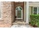 Close-up of a front door with stone accents and landscaped entrance at 1122 Cayuga Ct, Dacula, GA 30019