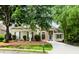 Charming one-story home with stone accents, manicured lawn and mature trees at 1122 Cayuga Ct, Dacula, GA 30019