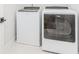 Modern laundry room with white washer and dryer, providing convenience and functionality at 1122 Cayuga Ct, Dacula, GA 30019
