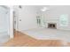 Open-concept living room with fireplace, hardwood floors, and high ceilings at 1122 Cayuga Ct, Dacula, GA 30019