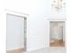 Bright room with high ceilings and transom. Features view to kitchen and living spaces at 1122 Cayuga Ct, Dacula, GA 30019