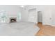 Bright living room with vaulted ceilings, fireplace, built-in shelving, and access to a door with glass panels at 1122 Cayuga Ct, Dacula, GA 30019