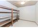 Large walk-in pantry with ample wooden shelving for organized storage at 1122 Cayuga Ct, Dacula, GA 30019