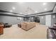 A large finished basement includes a sectional couch, and neutral carpet with a doorway at 3438 Winborn Walk Northwest Nw, Kennesaw, GA 30152