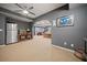 Partially finished basement area with an archway leading to a living space and a stainless-steel refrigerator at 3438 Winborn Walk Northwest Nw, Kennesaw, GA 30152