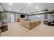 Finished basement with a large sectional sofa, flat screen television, and neutral carpeting at 3438 Winborn Walk Northwest Nw, Kennesaw, GA 30152