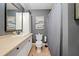 Neutral-toned bathroom with a vanity, toilet, and a shower/tub combo with a patterned shower curtain at 3438 Winborn Walk Northwest Nw, Kennesaw, GA 30152