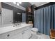 Bathroom featuring a white vanity, black wall, and a blue shower curtain at 3438 Winborn Walk Northwest Nw, Kennesaw, GA 30152