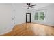 An empty bedroom features hardwood floors, neutral walls, and a large window letting in plenty of natural light at 3438 Winborn Walk Northwest Nw, Kennesaw, GA 30152
