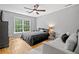Bedroom with hardwood floors, ceiling fan, a large window, and a sofa at 3438 Winborn Walk Northwest Nw, Kennesaw, GA 30152
