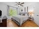 Bright bedroom with a queen-size bed, ceiling fan and a large window providing ample natural light at 3438 Winborn Walk Northwest Nw, Kennesaw, GA 30152