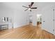 Large bedroom with hardwood flooring, a ceiling fan, and multiple doorways, showcasing a spacious layout at 3438 Winborn Walk Northwest Nw, Kennesaw, GA 30152