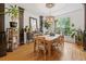 Stylish dining room with hardwood floors, natural light, and a charming chandelier above the wooden table at 3438 Winborn Walk Northwest Nw, Kennesaw, GA 30152