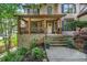 Inviting front porch with stone accents and wooden pillars, perfect for relaxing and enjoying the outdoors at 3438 Winborn Walk Northwest Nw, Kennesaw, GA 30152