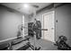 Home gym featuring weightlifting equipment, black rubber floor, and a white door at 3438 Winborn Walk Northwest Nw, Kennesaw, GA 30152