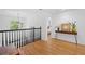 Upstairs hallway showcasing hardwood floors, natural light, and white walls at 3438 Winborn Walk Northwest Nw, Kennesaw, GA 30152