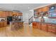 Spacious kitchen with wooden cabinets, an island with a stovetop, and hardwood floors at 3438 Winborn Walk Northwest Nw, Kennesaw, GA 30152