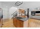 Open kitchen with wooden cabinets, island cooktop and stainless steel refrigerator at 3438 Winborn Walk Northwest Nw, Kennesaw, GA 30152