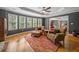 Spacious living room boasts hardwood floors, gray walls, tray ceiling, and large windows at 3438 Winborn Walk Northwest Nw, Kennesaw, GA 30152